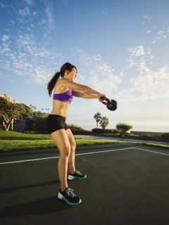 Young woman exercising with kettlebell