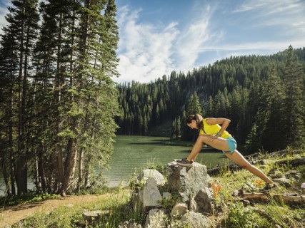 Woman stretching in forest