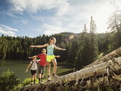 Children (10-11, 12-13, 14-15) walking on log