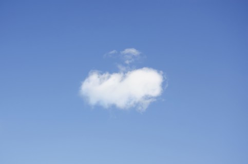 Single cumulus cloud in blue sky