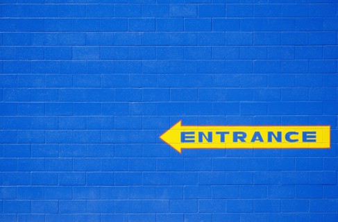Blue wall with yellow entrance sign