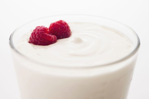 Yogurt with raspberries in drinking glass