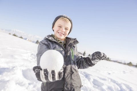 Portrait of boy (8-9) holding snowball