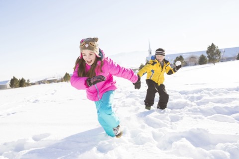 Children (8-9, 10-11) playing in snow