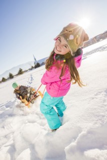 Children (8-9, 10-11) playing with sled