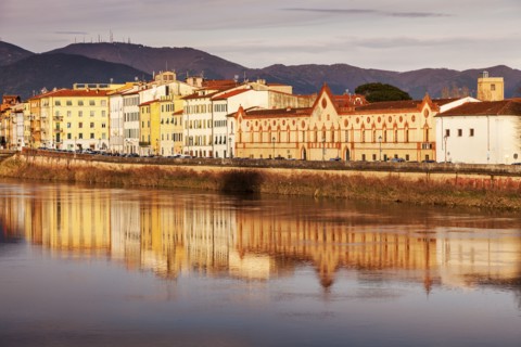 Townhouses by Arno river at sunset