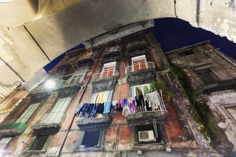 Low angle view of residential building with laundry on balconies