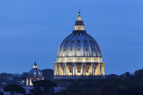 Illuminated St. Peter's Basilica at dusk