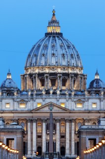 Illuminated St. Peter's Basilica at dusk