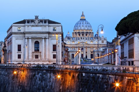 Illuminated St. Peter's Basilica at dusk