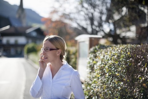 Woman wearing white shirt talking on phone