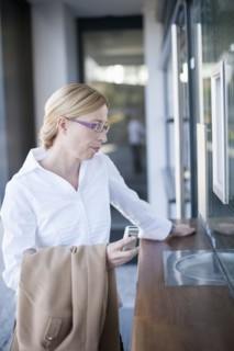 Businesswoman standing by ticket counter