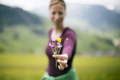 Woman holding wild flowers