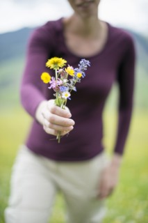 Woman holding wild flowers