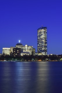 Illuminated waterfront buildings at dusk