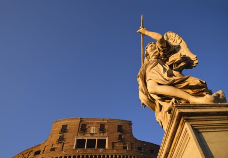 Statue of angel and Castle Sant' Angelo against clear sky