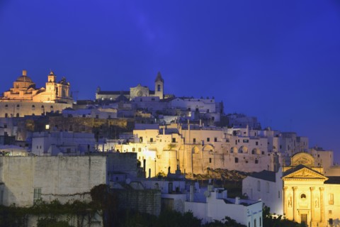 Old town against sky at dusk