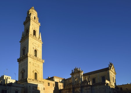 Bell tower and cathedral against clear sky