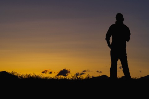 Silhouette of man standing at dusk
