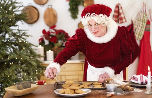 Mrs. Claus making gingerbread cookies.