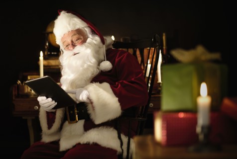 Santa Claus using digital tablet.