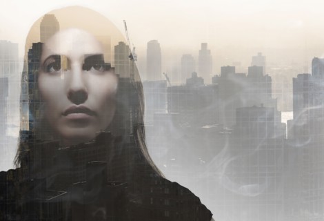 Double exposure of young woman's face over cityscape. USA, New York, New York City.