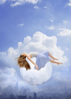 Young woman floating on bubble over cityscape. USA, New York, New York City.