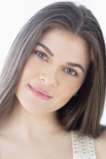 Portrait of young woman with brown hair.