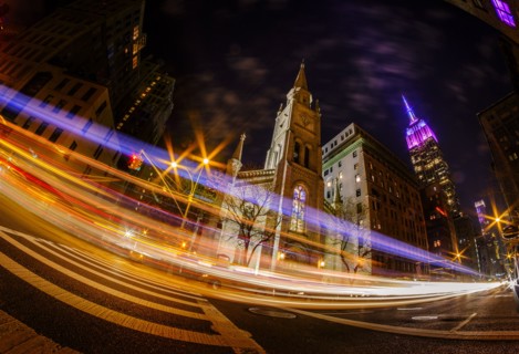 St Bartholomew's Church at night with long exposure of traffic at night. USA, New York, New York City.