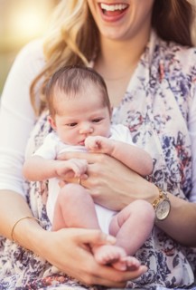 Mother holding daughter (2-5 months)