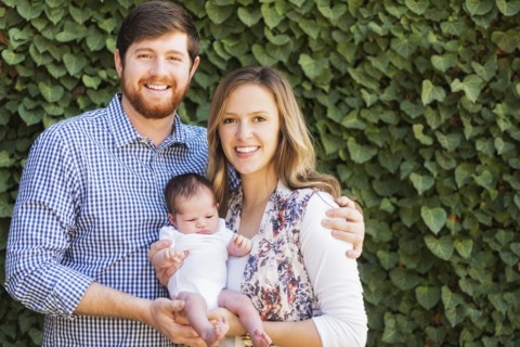 Happy parents holding girl (2-5 months)