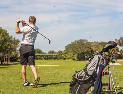 Mid adult man playing golf