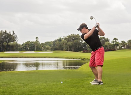 Mid adult man playing golf