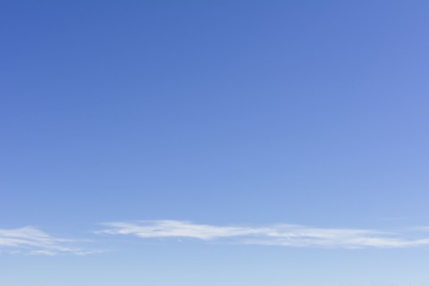 Clear blue sky with scattered clouds