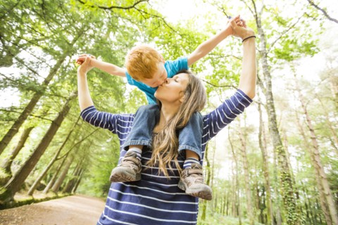 Mother carrying on shoulders son (2-3)