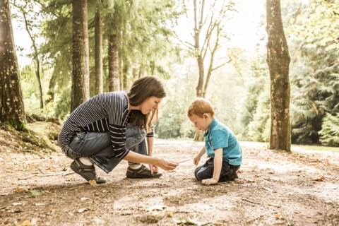 Mother playing with son (2-3) in park