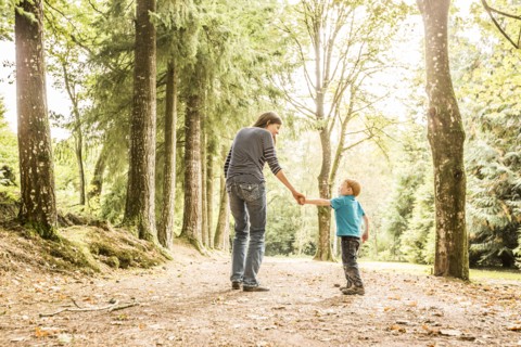 Mother walking with son (2-3) in park