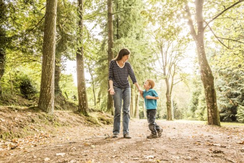 Mother walking with son (2-3) in park