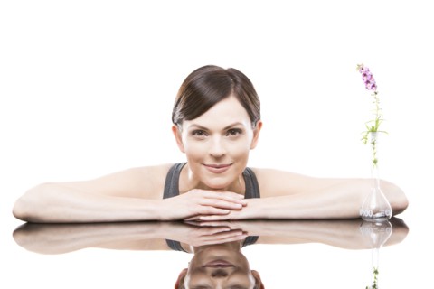 Portrait of woman leaning on mirror