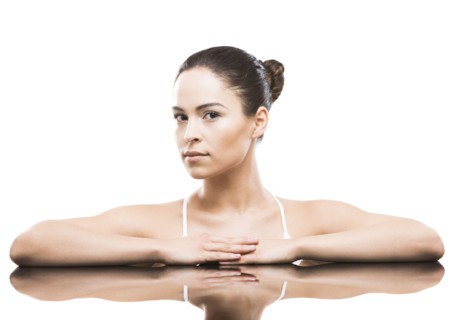 Portrait of woman leaning on mirror