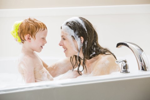 Mother and son (2-3) having bubble bath