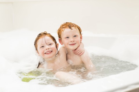 Sister and brother (2-3, 4-5) having bubble bath
