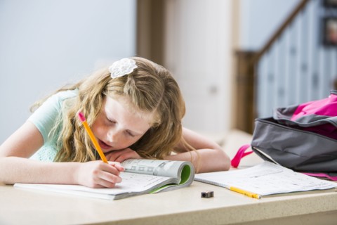 Girl (8-9) doing homework