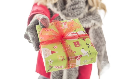 Young woman holding Christmas present