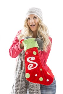 Portrait of young woman holding Christmas stocking