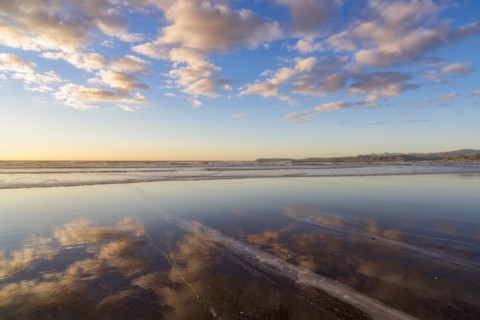 Cloudy sky reflected in sea