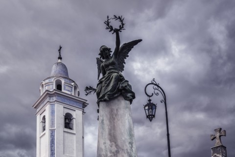 Statue and bell tower of Our Lady Del Pilar Church