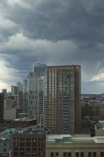 Downtown district against cloudy sky
