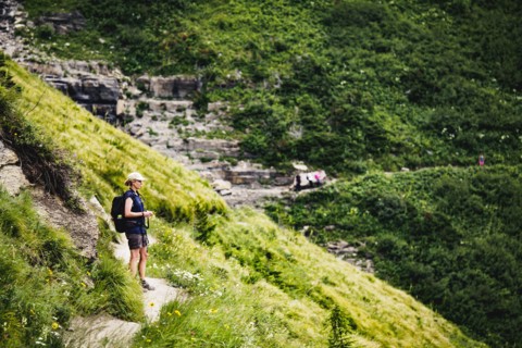 Mature woman standing on path in mountains