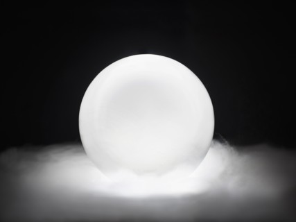 Glowing crystal ball in smoke.